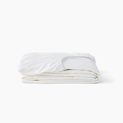 A folded white Beautyrest mattress protector with an elasticized top edge, photographed on a clean white background.