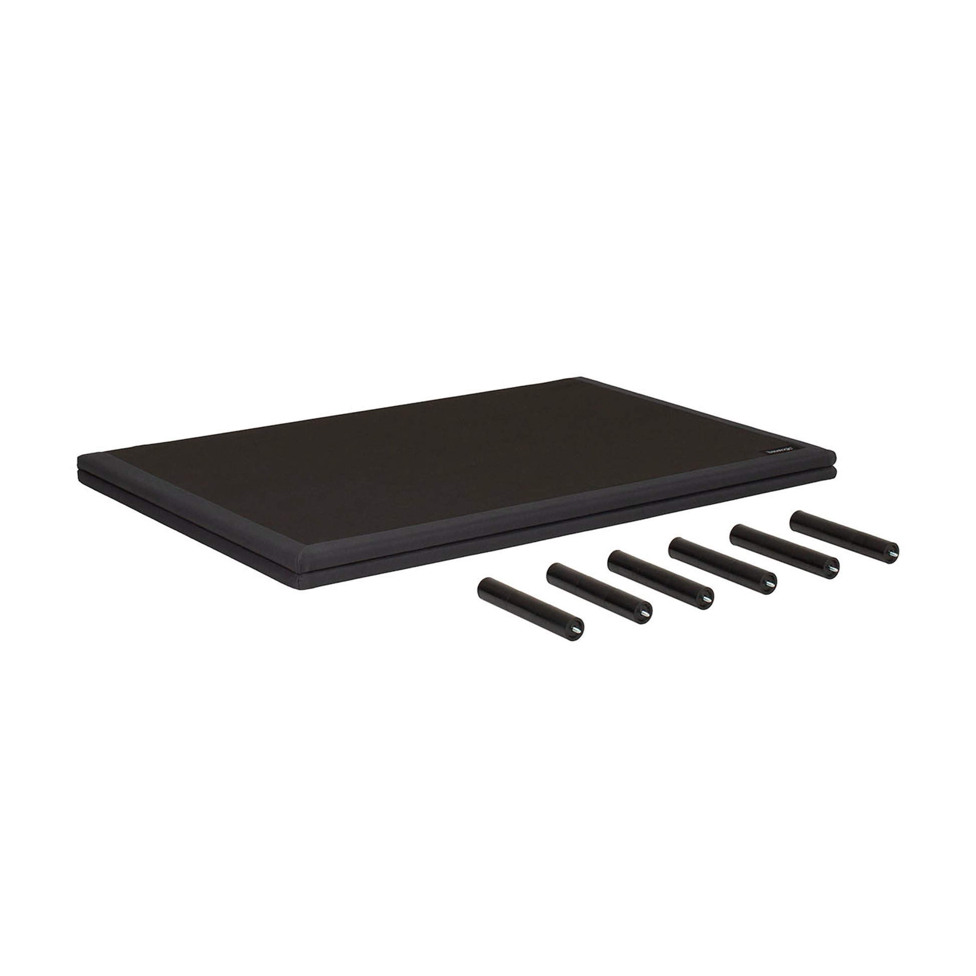 A black rectangular mat or pad shown on a plain white background, with five black cylindrical pieces placed in front of it.