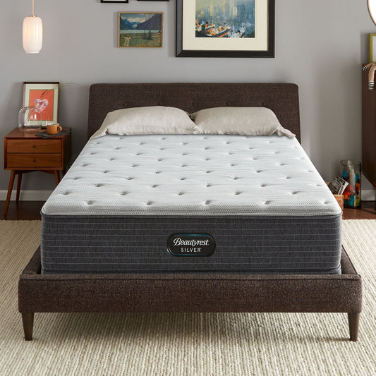 The Beautyrest Silver BRS900 Plush mattress in a bedroom on a brown bed