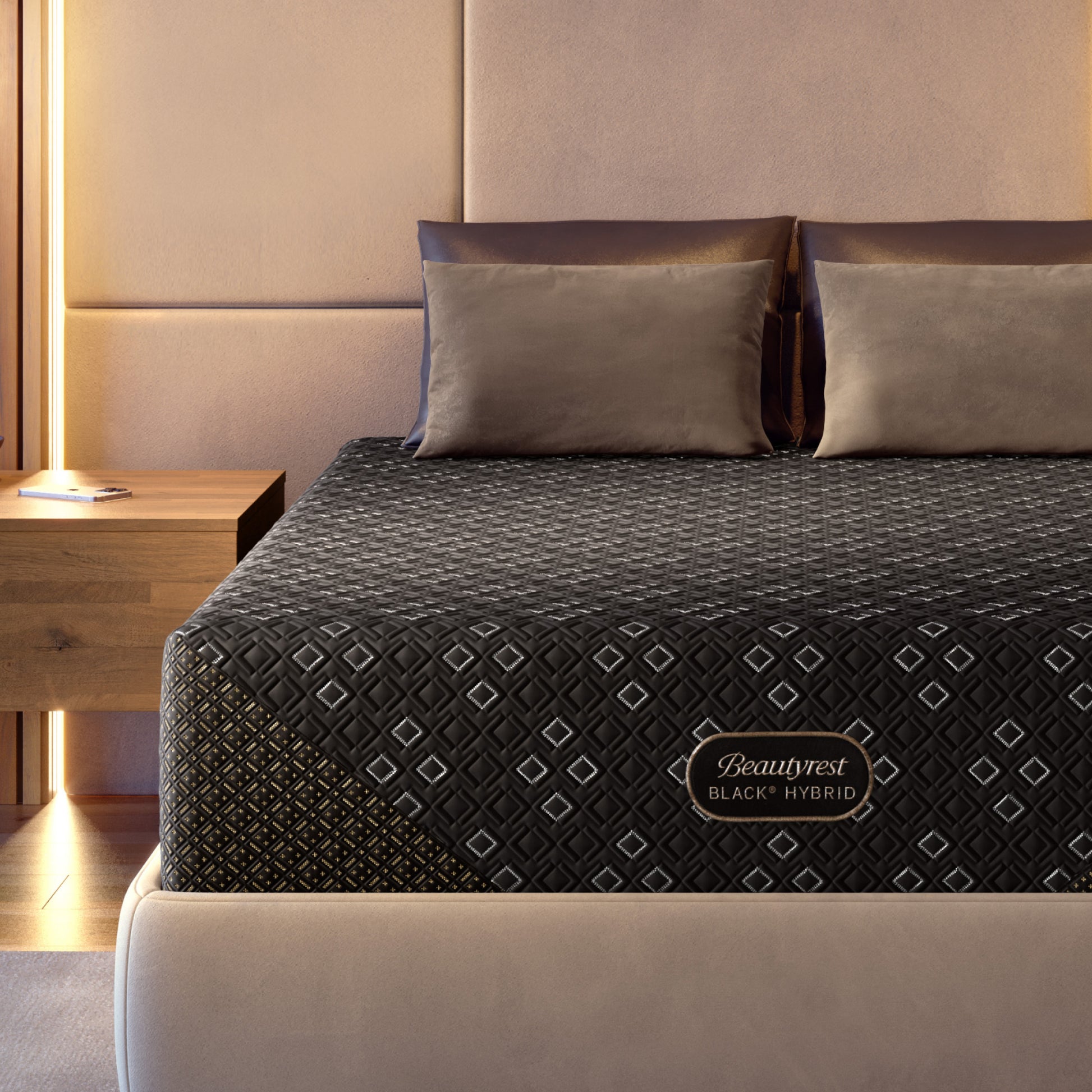 Beautyrest Black Hybid XCS mattress with decorative cover on a bed in a bedroom setting.