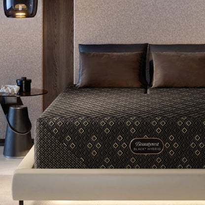 Beautyrest Black Hybid XCS Medium mattress with decorative cover on a bed in a modern bedroom setting.
