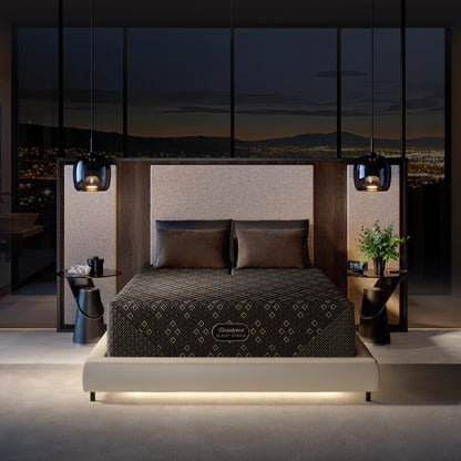 Modern bedroom with a Beautyrest Black Hybid XCS Medium mattress in a beige bed frame and cityscape view